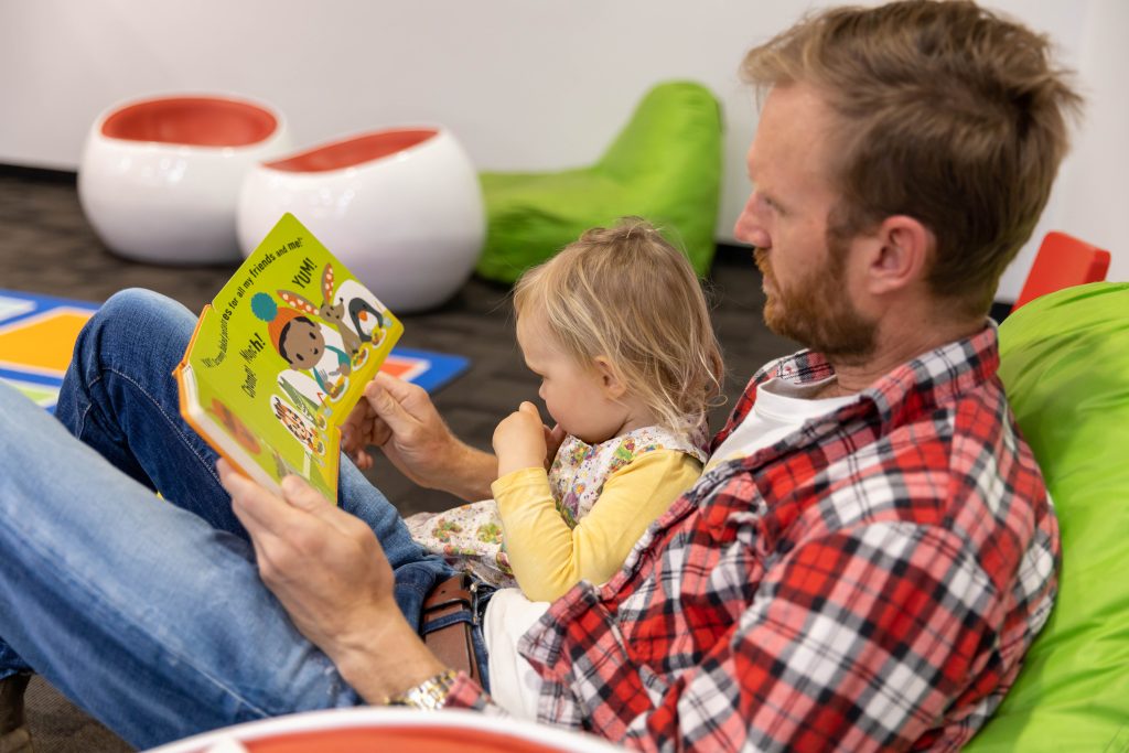 Photo of father reading to child - Launceston Library