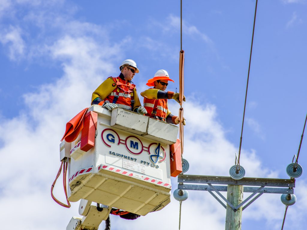 26ten workplace grant project - TasNetworks.  Photo of two men fixing power lines.